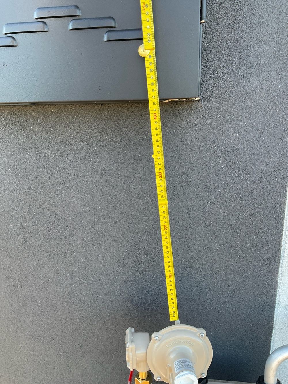 Gas meter sited inside the electrical meter exclusion zone, found during a practical completion inspection in Tarneit
