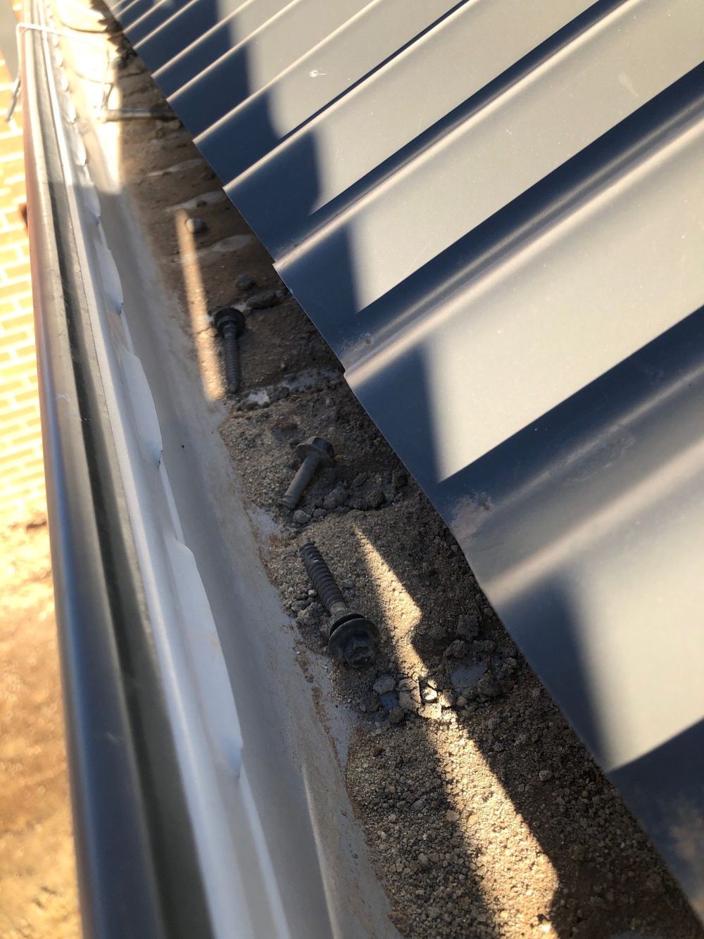 Gutters full of building debris at handover, found during a practical completion inspection in Tarneit